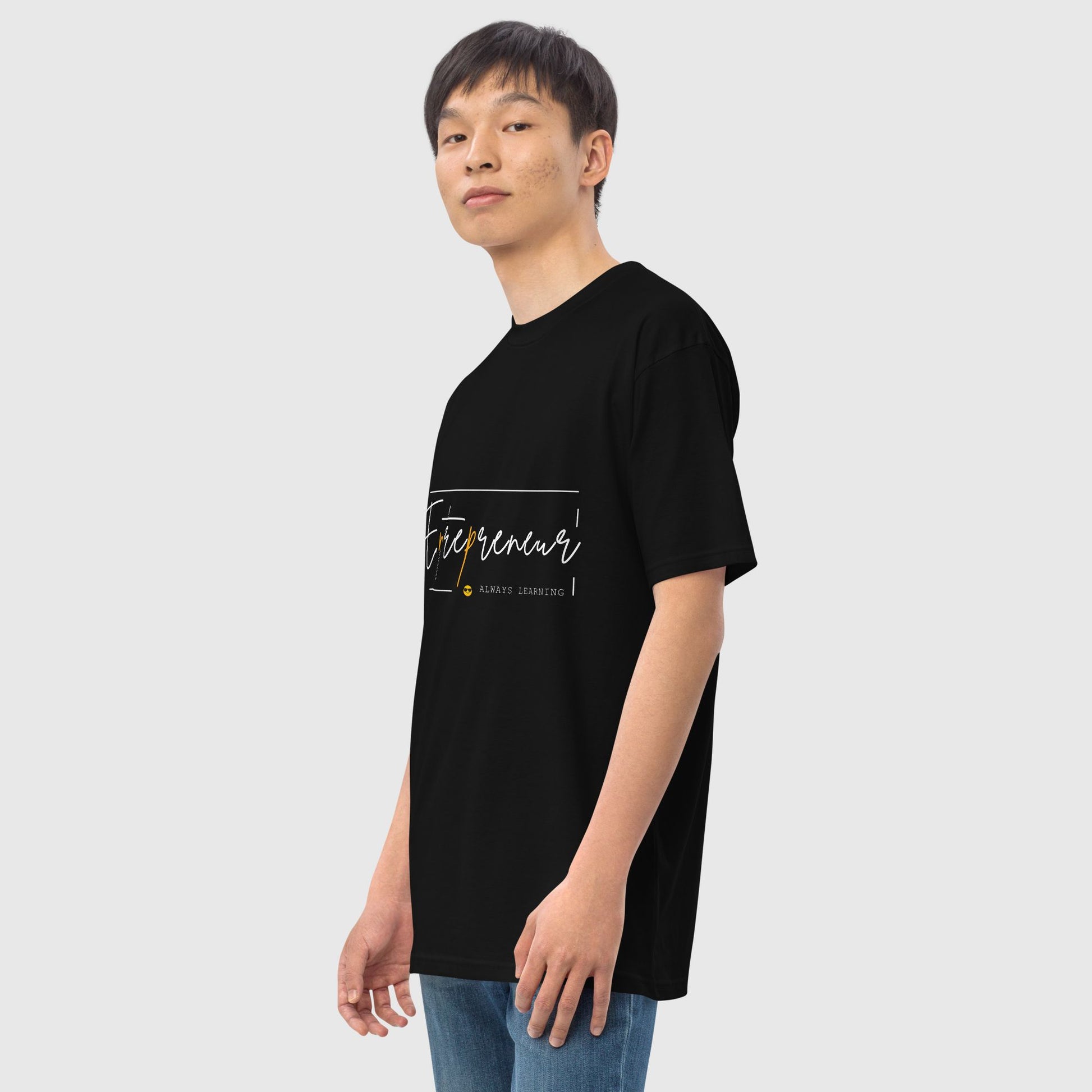 Man's side pose wearing a black t shirt with  graphic print that says, entrepreneur mentality