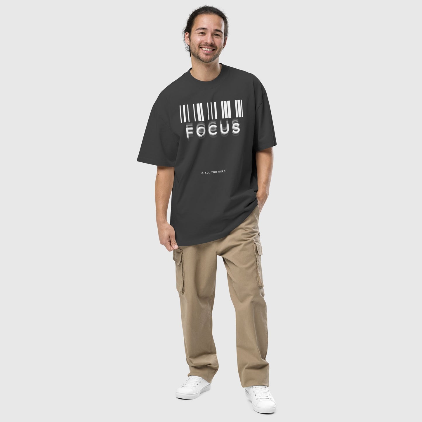 man wearing printed graphic oversized shirt in black colour with print saying, "focus is all you need"