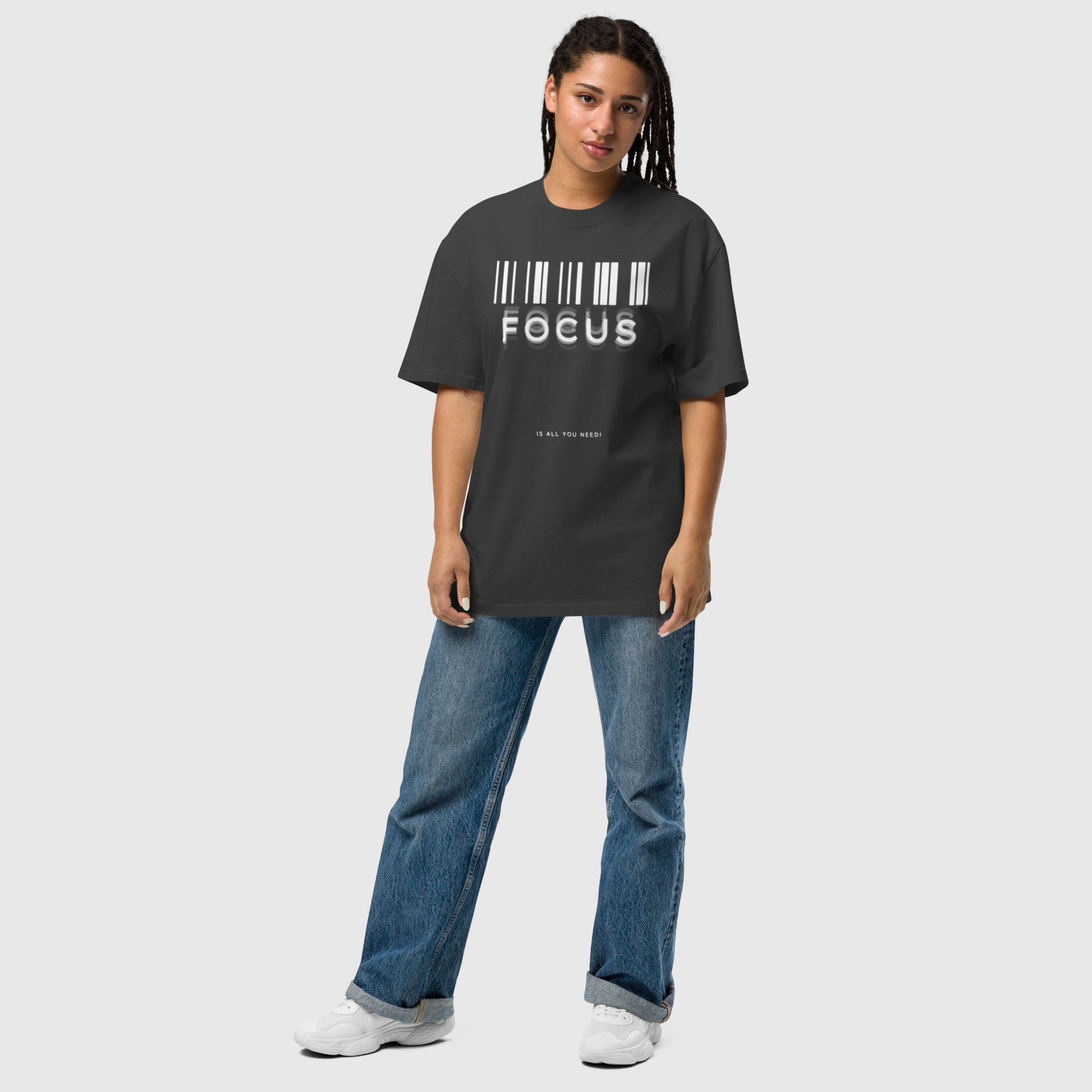 woman wearing printed graphic oversized shirt in black colour with print saying, "focus is all you need"