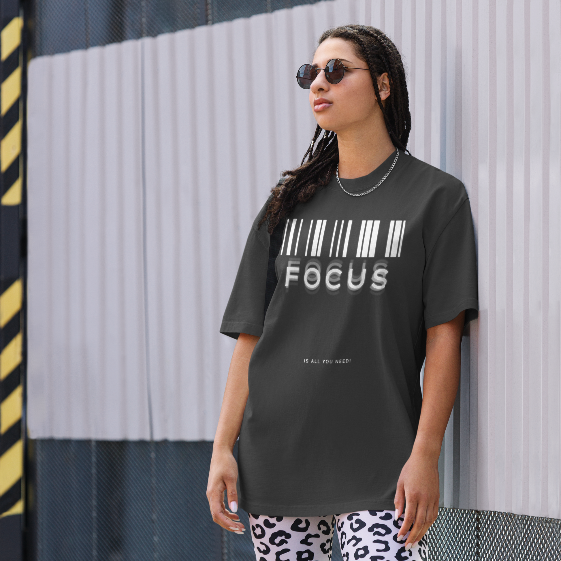 woman on street wearing printed graphic oversized shirt in black colour with print saying, "focus is all you need"