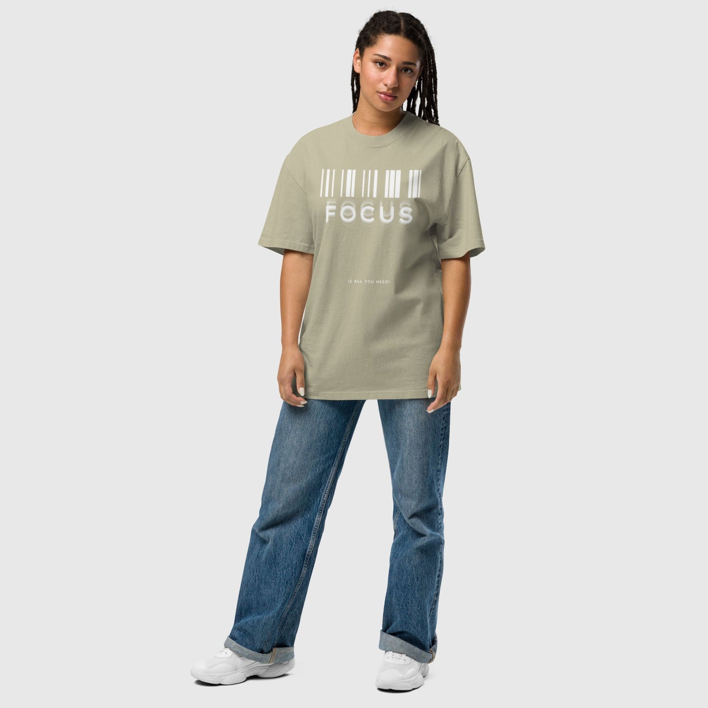 woman wearing printed graphic oversized shirt in faded eucalyptus colour with print saying, "focus is all you need"