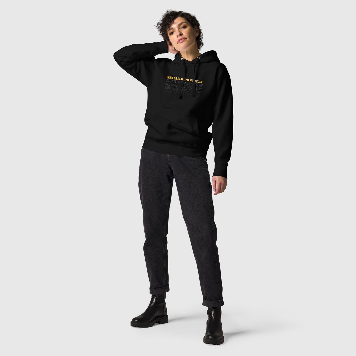 Women posing, wearing a black hoodie that has a motivational quote "Imma be always hustlin'"