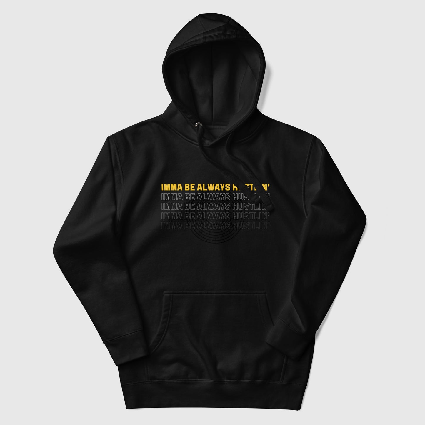 A black hoodie that has a motivational quote "Imma be always hustlin'"printed on it lying like a flat lay.