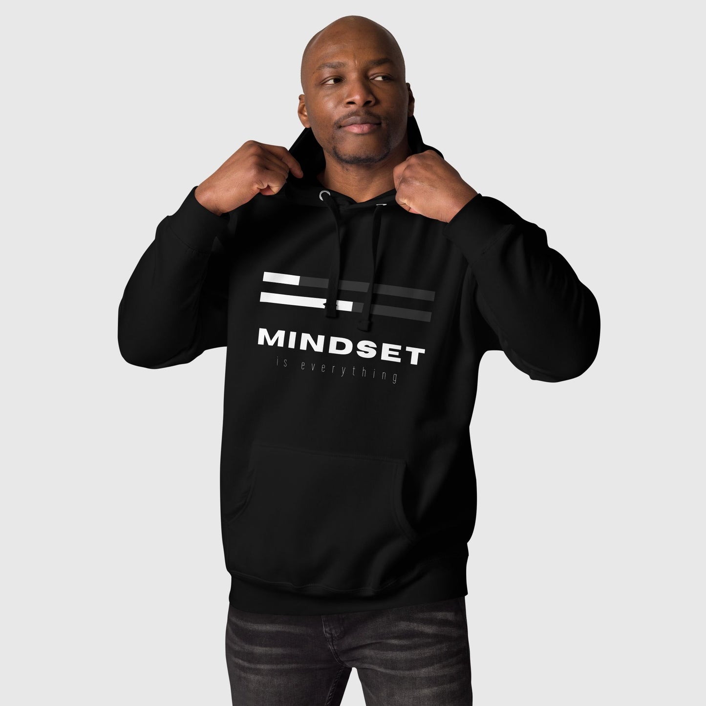 Man posing with a black hoodies that says "Mindset is everything" 