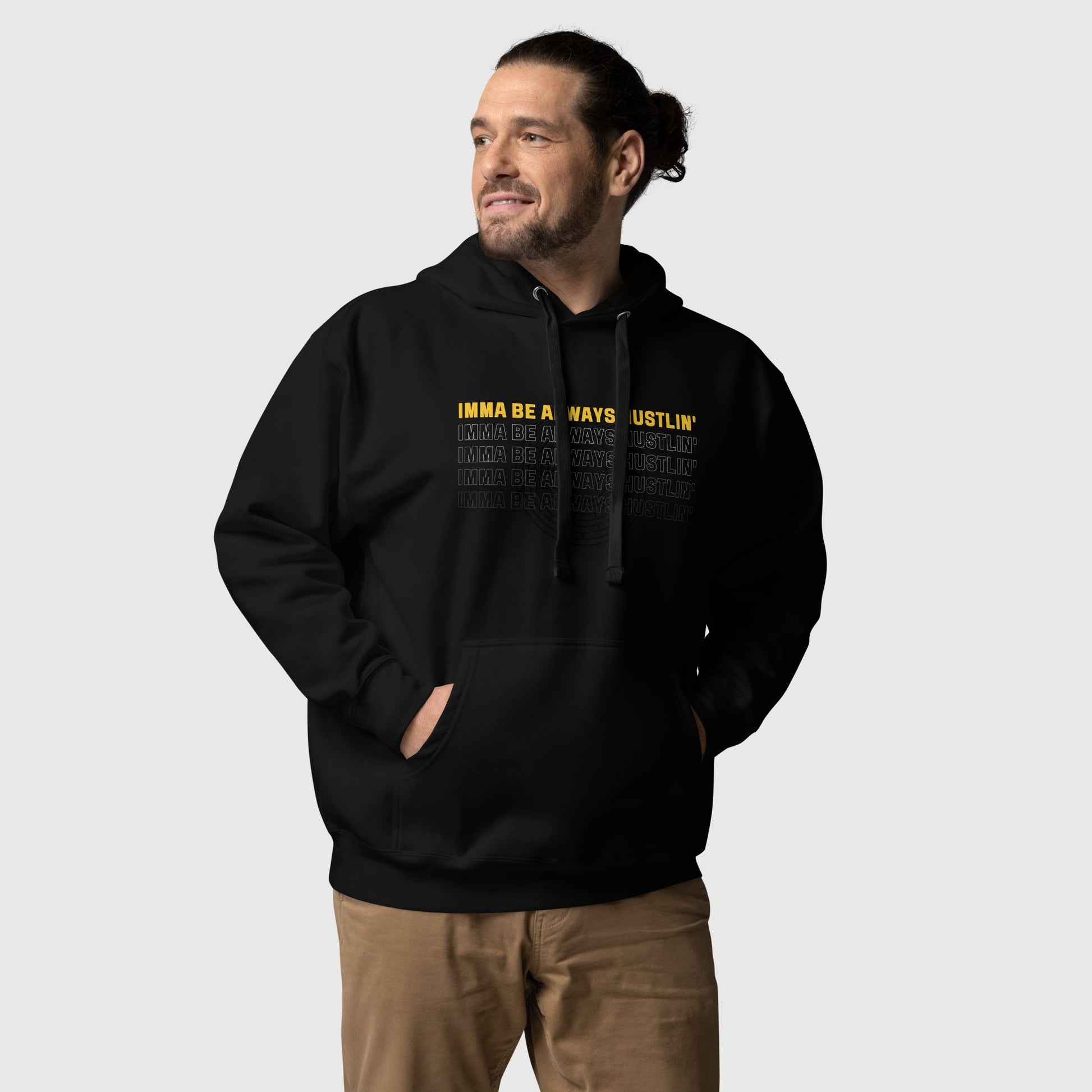 Man wearing a black hoodie that has a motivational quote "Imma be always hustlin'" printed on it