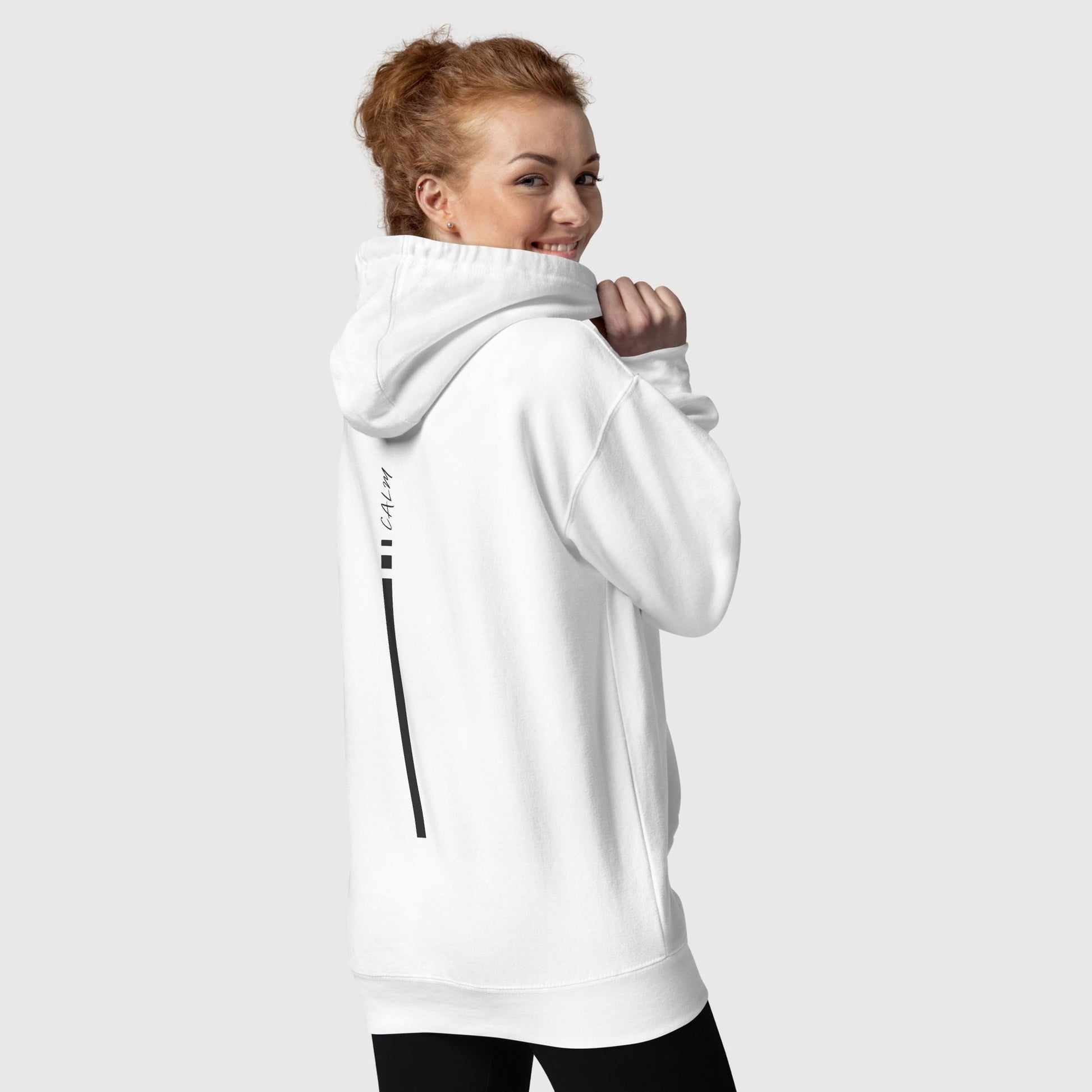 women posing and smiling wearing a white hoodie that has a graphic print on back