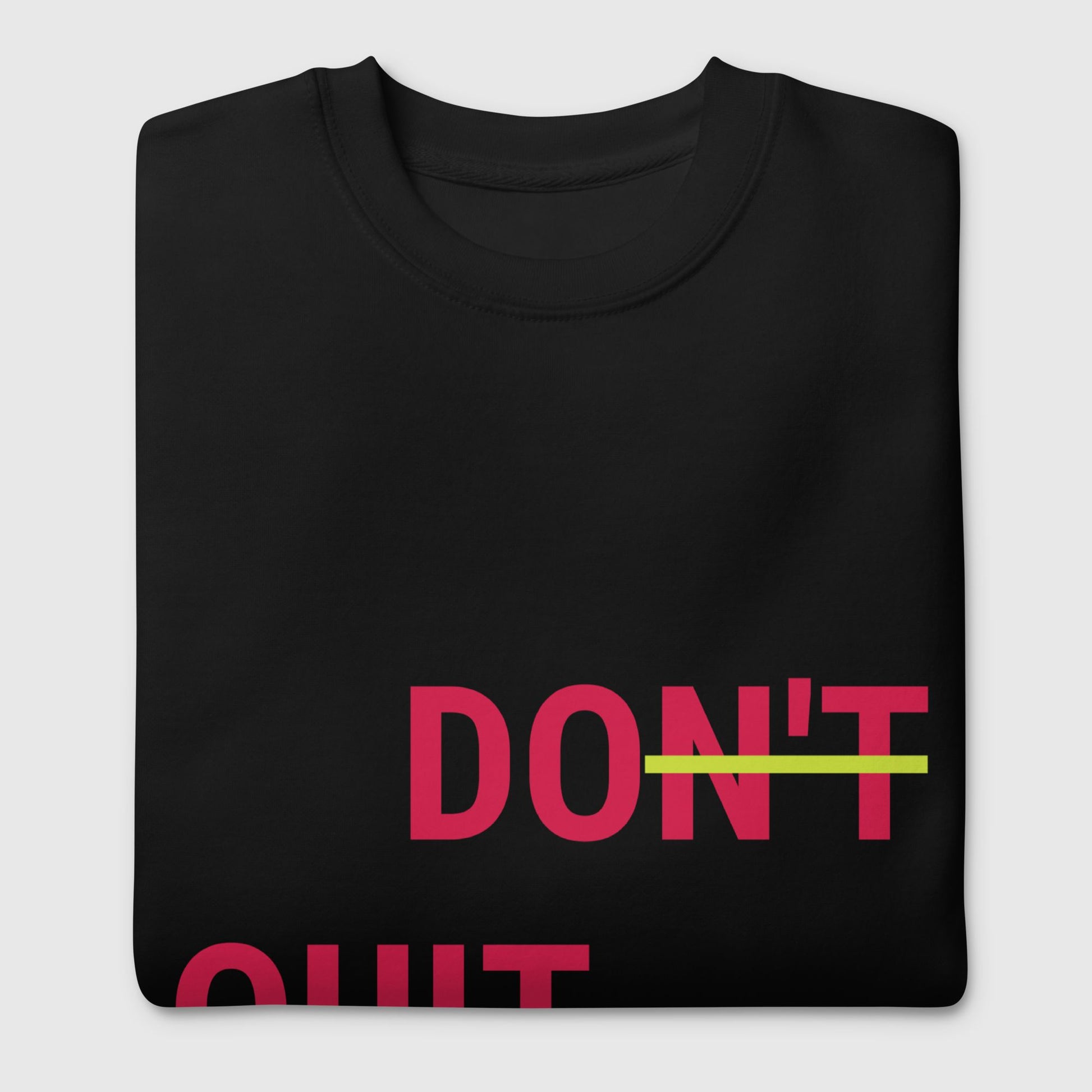 a folded black don't quit, do it sweatshirt